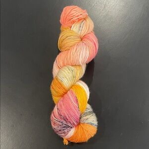 New yarn skein of hand dyed sock wool approximately 400 yards